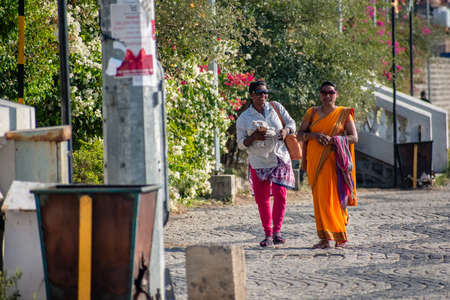 Nagpur, Maharahstra, India - March 2019: Two cheerful Indian women wearing sunglasses hanging out at...