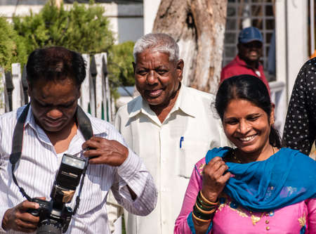 Nagpur, Maharashtra, India - March 2019: An elderly Indian man smiles while walking on the streets.