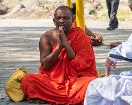 Nagpur, Maharashtra, India - March 2019: A Buddhist monk folds his hand and chants prayers at the pilgrimage site of Deekshabhoomi in the city of Nagpur.のeditorial素材