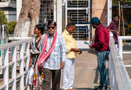Nagpur, Maharashtra, India - March 2019: A candid portrait of a middle-aged Indian man walking with his sunglasses in the streets of the city.のeditorial素材