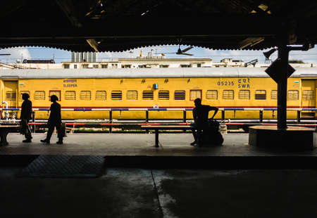 Bangalore, Karnataka, India - January 2020: A train painted yellow stationary at a platform on the Bengaluru Railway station.のeditorial素材