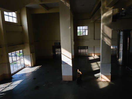 Chennai, Tamil Nadu, India - January 2020: A woman walking alone inside the deserted hall of the Kasturba Nagar station on the Chennai MRTSのeditorial素材