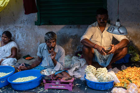 Chennai, Tamil Nadu, India - August 2018: Portrait of an Indian flower seller in his shop on the...