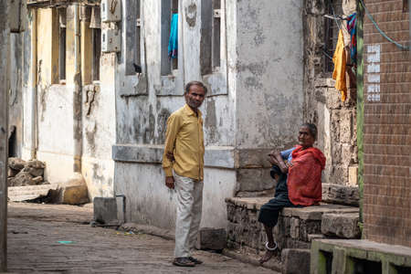 Somnath, Gujarat, India - December 2018:  An elderly Indian man and a women hanging out in an alley.のeditorial素材