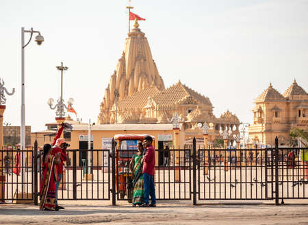 Somnath, Gujarat, India - December 2018:  A family of Indian tourists get their pictures taken outside the ancient Hindu temple in the holy town.のeditorial素材