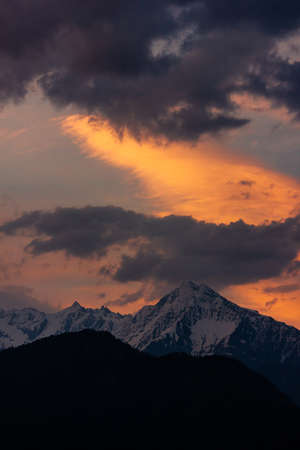 Sunset colours fill the sky above the Himalayan mountain of Shrikhand Mahadev in Sarahanの写真素材