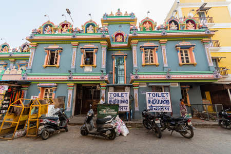Pondicherry. India - February 2020: A temple with parked motorbikes and signs pointing to toilets...