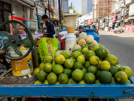 Trichy, Tamil Nadu, India - February 2020: Sweet Lime piled on a cart at a roadside fruit juice shop in Tiruchirappalli.のeditorial素材