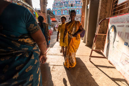 Trichy, Tamil Nadu, India - February 2020: Indian pilgrims walking inside the entrance gate to the ancient Jambukeshwar temple in Tirchirappalli.のeditorial素材