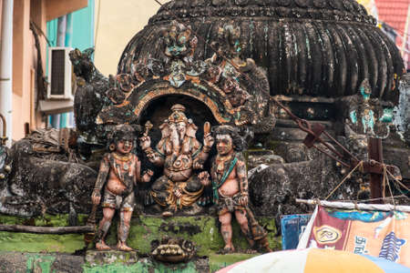 Mayiladuthurai, Tamil Nadu, India - February 2020: Faded carvings of the Hindu God Ganesha on the weathered roof of a shrine inside the ancient Hindu temple at Vaitheeswaran Koil.のeditorial素材