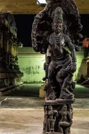 Kumbakonam, Tamil Nadu, India - February 2020: Sculpture of a Hindu Goddess on a pillar in a dark corner of an ancient temple in the outskirts of Kumbakonam.のeditorial素材