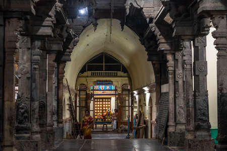 Kumbakonam, Tamil Nadu, India - February 2020: The stone pillars of an arched hallway inside an ancient Hindu temple in Kumbakonam.のeditorial素材