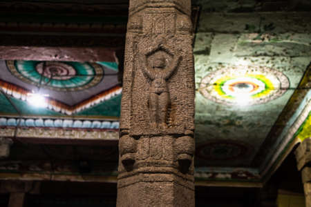 Carving of figurine praying on a stone pillar inside an an ancient Hindu temple in Kumbakonam in Tamil Nadu, India.のeditorial素材