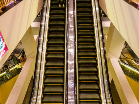 Chennai, Tamil Nadu, India - January 2020: An escalator inside a modern shopping mall in Chennai.のeditorial素材