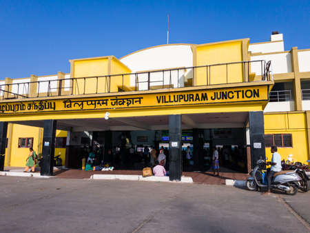 Villupuram, Tamil Nadu, India - January 2020: The exterior facade of the Villupuram Junction railway station painted a bright yellow against a blue sky.のeditorial素材