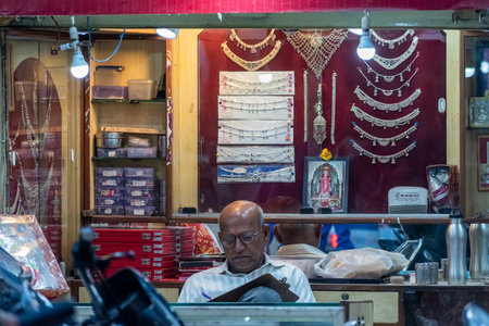 Bhopal, Madhya Pradesh,India - March 2019: Portrait of an Indian merchant sitting inside his jewelry store.のeditorial素材