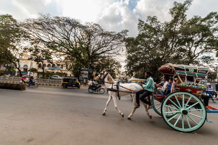 Mysuru, Karnataka, India - January 2019: A horse cart with passengers riding through the streets in the city of Mysore.のeditorial素材