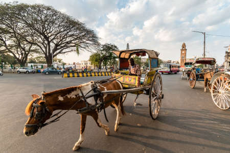 Mysuru, Karnataka, India - January 2019: A man riding a horse cart on the streets of the city of Mysore.のeditorial素材