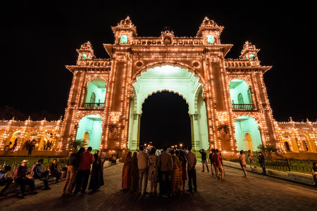 Mysuru, Karnataka, India - January 2019: Crowds of tourists at the historic Mysore Palace of the Wodeyar dynasty illuminated in the evening.のeditorial素材