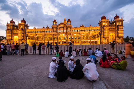 Mysuru, Karnataka, India - January 2019: Crowds of tourists at the historic Mysore Palace of the Wodeyar dynasty illuminated in the evening.のeditorial素材