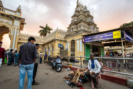 Mysuru, Karnataka, India - January 2019: A street vendor selling goods outside an ancient Hindu temple at the Mysore Palace.のeditorial素材
