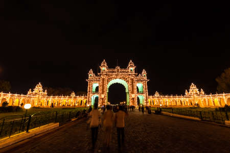 Mysuru, Karnataka, India - January 2019: Crowds of tourists at the historic Mysore Palace of the Wodeyar dynasty illuminated in the evening.のeditorial素材