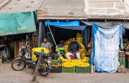 Mysuru, Karnataka, India - January 2019: Indian street vendors selling fruits at a stall in the Devaraj market in the city of Mysore.のeditorial素材