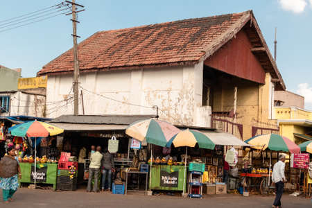 Mysore, Karnataka, India - January 2019: Shops in a crowded market below the slanted roofs of an old building in the Chamundi Hills area of the city of Mysuru.のeditorial素材