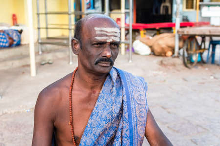 Mysuru, Karnataka, India - January 2019: Portrait of a Hindu temple priest in ethnic attire with striped holy ash on his forehead in the ancient temple of Chamundeshwari in Chamundi Hills.のeditorial素材