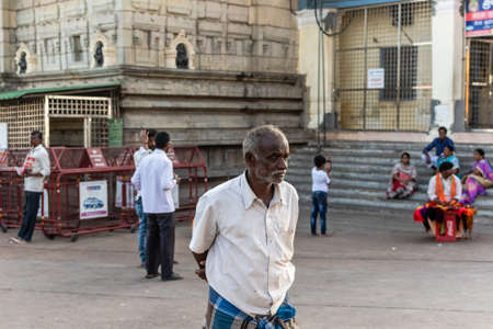 Mysuru, Karnataka, India - January 2018: An elderly Indian man staring sadly outside an ancient Hindu temple in the Chamundi Hills in Mysore.のeditorial素材