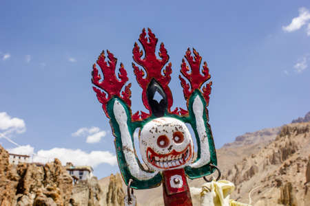 Dhankar, Himachal Pradesh, India - May 2012: A Tibetan Buddhist demonic totem meant to keep away evil spirits on the roof of an ancient Himalayan monastery in the Spiti Valley.の写真素材