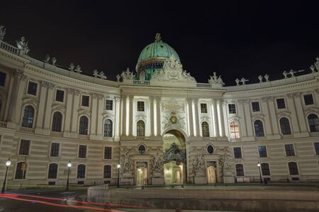 The building of the St. Michael wing (Michaelertrakt) of the Hofburg Palace with night illuminationのeditorial素材