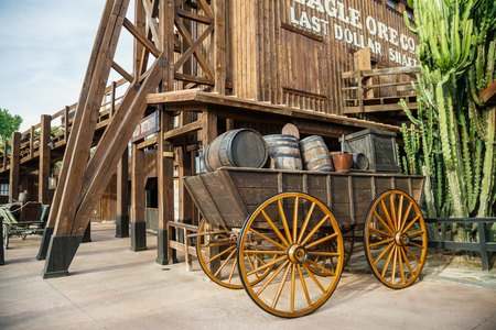 PORT AVENTURA, SPAIN - MAY 11, 2015. Old wooden wagon near the attraction Wild Buffalos in the Far West area of theme park Port Aventura in city Salou, Spain.のeditorial素材