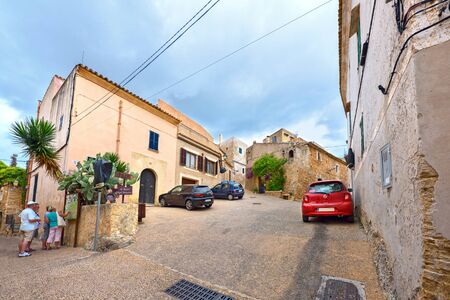CAPDEPERA, SPAIN - JUNE, 16. Tourists on the streets of the old village Capdepera on June 16, 2016. Island Majorca, Spain.のeditorial素材