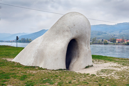 SANKT LORENZ, AUSTRIA - APRIL 3, 2017. Huge sculpture The Wachauer Nase located on the Danube next to the ferry station in village St. Lorenz. Wachau Valley, Lower Austria.のeditorial素材