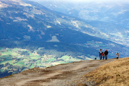 GOLDECK/ AUSTRIA - OCTOBER 8, 2017. People walking on a mountain road from the cable car station Goldeck. The Alps, Carinthia, Austria.のeditorial素材