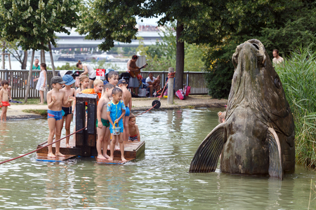 VIENNA/ AUSTRIA - JULY 9, 2017. Donauinsel water playground for children (Wasserspielplatz). Children on a wooden ferry. Danube Island, district Donaustadt, Vienna, Austria.のeditorial素材
