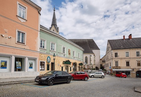 YBBS AN DER DONAU, AUSTRIA - JULY 8, 2018. View of the old cobbled square and St. Lorenz church om a summer cloudy day. Ybbs an der Donau, district Melk, Lower Austria, Europe.のeditorial素材