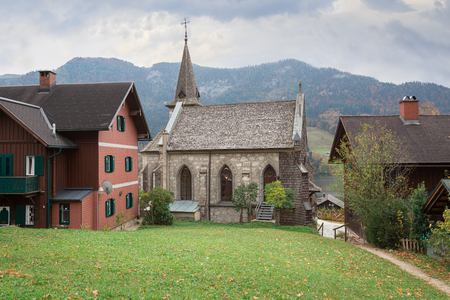 Town of Grundlsee with the old parish church on a cloudy autumn day. Region of Salzkammergut, Federal state of Styria, Austria.のeditorial素材