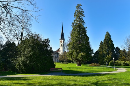 Villette-park in the town of Cham on a spring sunny day. View of the Saint Jacob Church. Cham,...