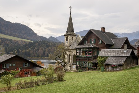 Traditional old wooden houses of the town of Grundlsee on a cloudy autumn day. View of the Alps. Region of Salzkammergut, Federal state of Styria, Austria, Europe.の写真素材