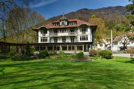 WEESEN, SWITZERLAND - APRIL 16, 2019. Beautiful house on the background of the Alps on a sunny spring day. Village of Weesen, See-Gaster, canton of St. Gallen, Switzerlandのeditorial素材