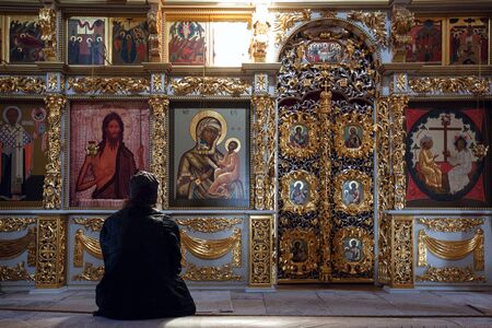SVIYAZHSK, RUSSIA - AUGUST 20, 2019. Prist praying in the Assumption Cathedral of 16th century, located on the territory of Assumption male monastery. Town of Sviyazhsk, Republic of Tatarstan, Russia.のeditorial素材