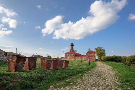 Garbage containers in front of the historical building of the fire house of the 19th century. Town...