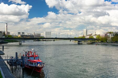 BASEL, SWITZERLAND - APRIL 17, 2019. The ship of Basel Fire Department at its usual mooring area in front of bridge Johanniterbruecke. City of Basel, Switzerland, Europe.のeditorial素材