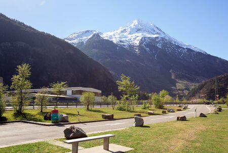 Rest Area on the highway along the river Reuss near the town of Silenen on a sunny spring day. View of the snow-capped mountain Bristen. Canton of Uri, Switzerland.の写真素材