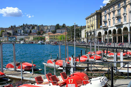 LUGANO, SWITZERLAND - APRIL 17, 2018. Embankment of the lake Lugano in city of Lugano on a spring sunny day. Water bike and boat rental. Lugano, canton of Ticino, Switzerland, Europe.のeditorial素材