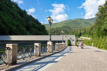 ESTOSADOK, RUSSIA - AUGUST 26, 2020. Polyanka embankment of Laura river. View of the pipeline bridge in front of Gazprom ski resort center. Village of Estosadok in the Adler district of Sochi, Russia.のeditorial素材