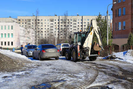 BALASHIKHA, RUSSIA - MARCH 19, 2021. Residential area on the spring sunny day. Road covered with melted snow and ice. City of Balashikha, Moscow region, Russia.のeditorial素材