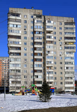 BALASHIKHA, RUSSIA - MARCH 19, 2021. View of the courtyard of a multi-storey residential building with a modern playground. Typical plattenbau. City of Balashikha, Moscow region, Russia.のeditorial素材